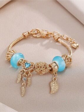 Gold-Tone Bracelet with Blue Glass Beads and Leaf Charms